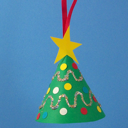 Miniature Christmas tree ornament decorated with paper punches, glitter and ribbon.