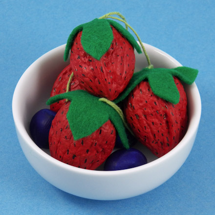 Three walnut strawberries in a bowl with hazelnut blueberries